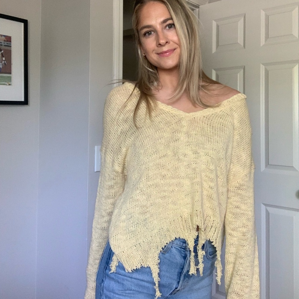 Distressed light yellow sweater